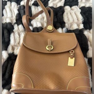 vintage Dooney & Bourke Cabriolet perforated leather backpack.